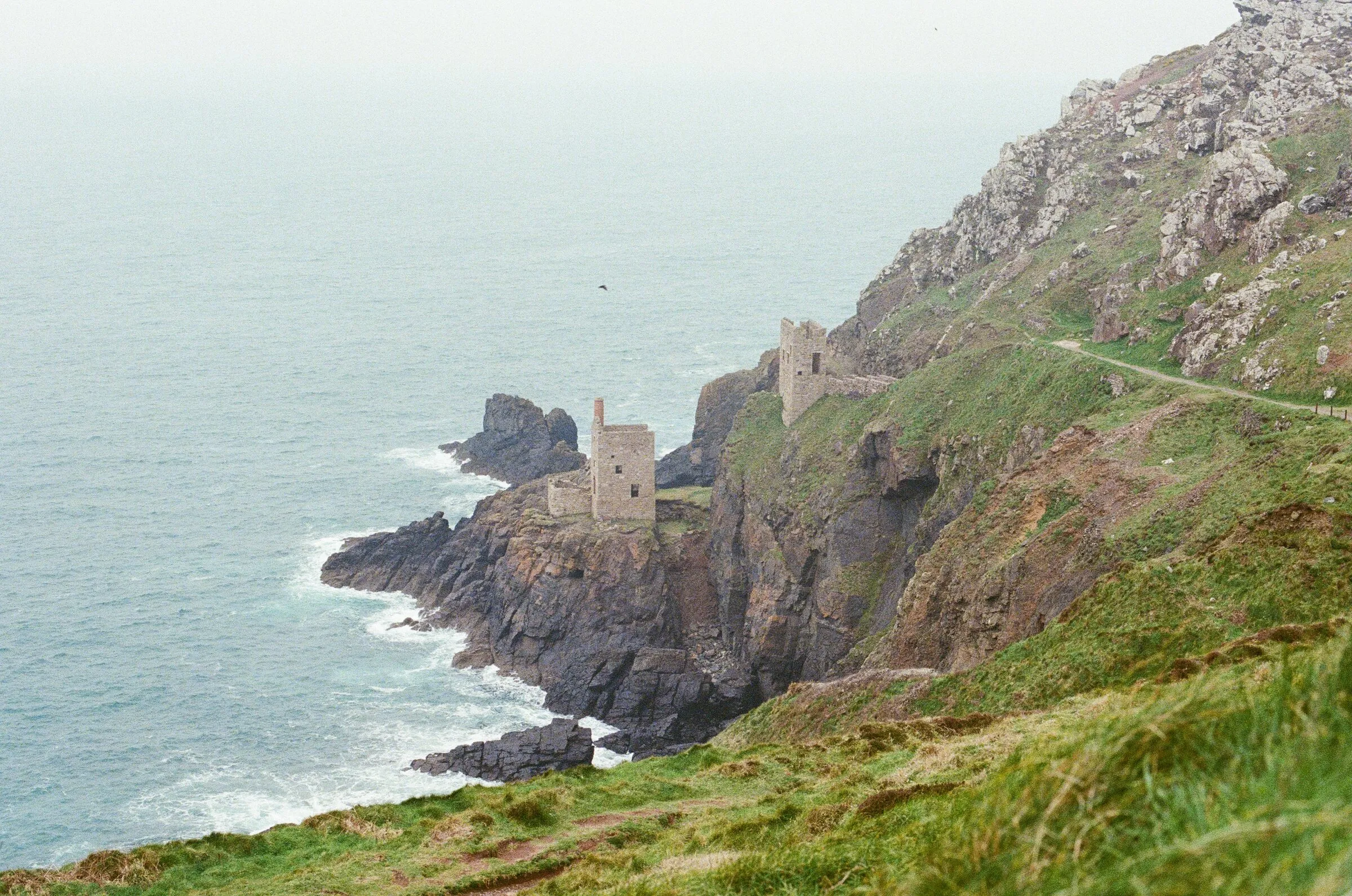 Sea cliffs and old mine engine houses in Cornwall
