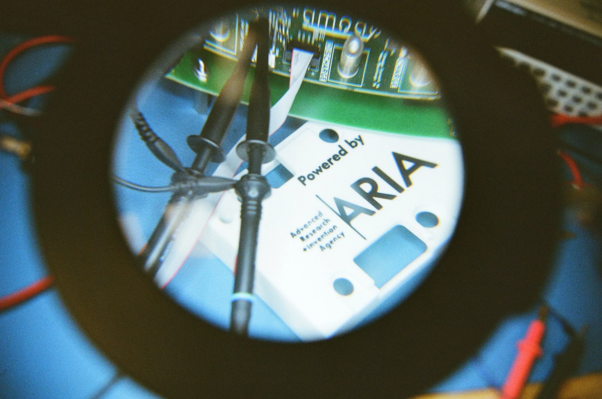 A magnifying lamp over a circuit board