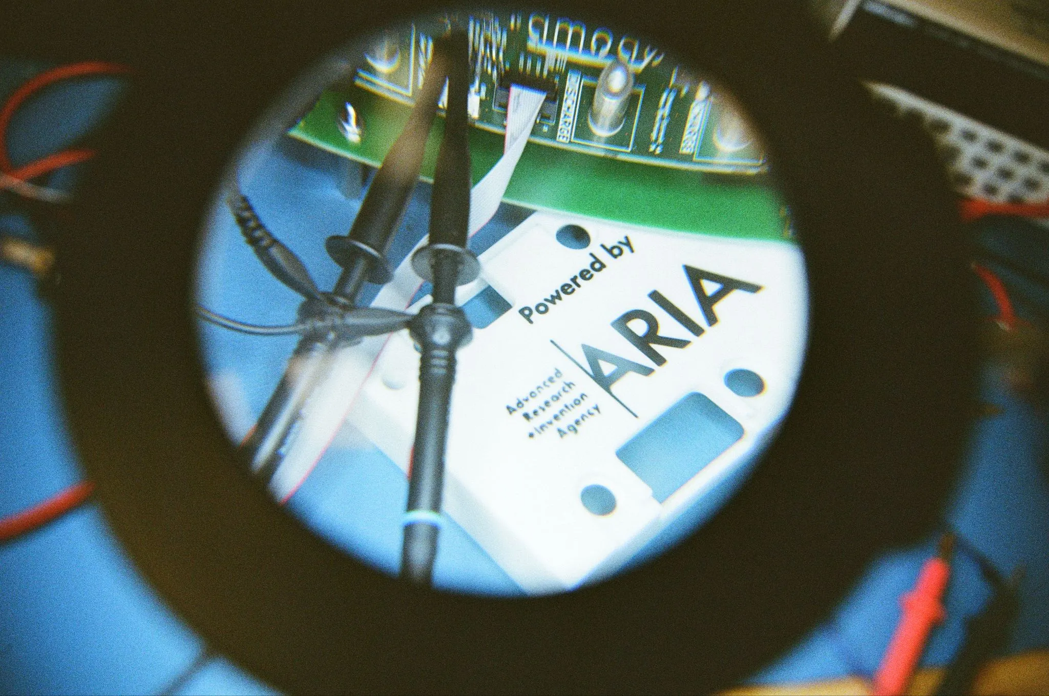 A magnifying lamp over a circuit board