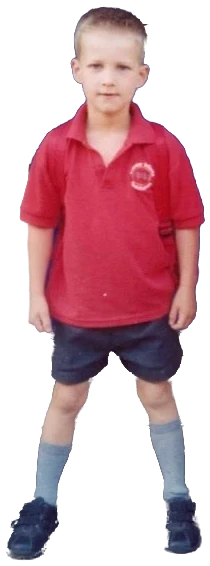 Thomas as a boy in a red school polo shirt