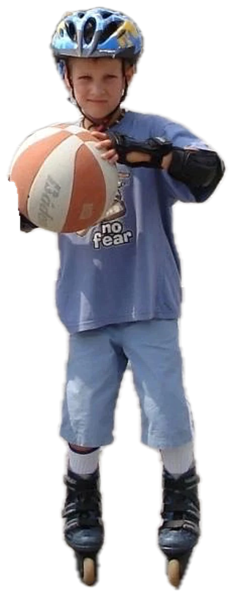 Thomas as a boy on inline skates, holding a basketball, about 2006