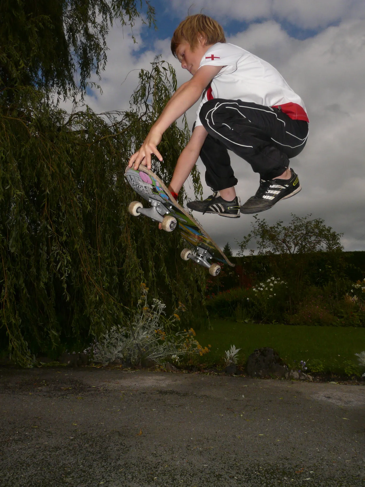 A boy doing a skateboard trick in the air