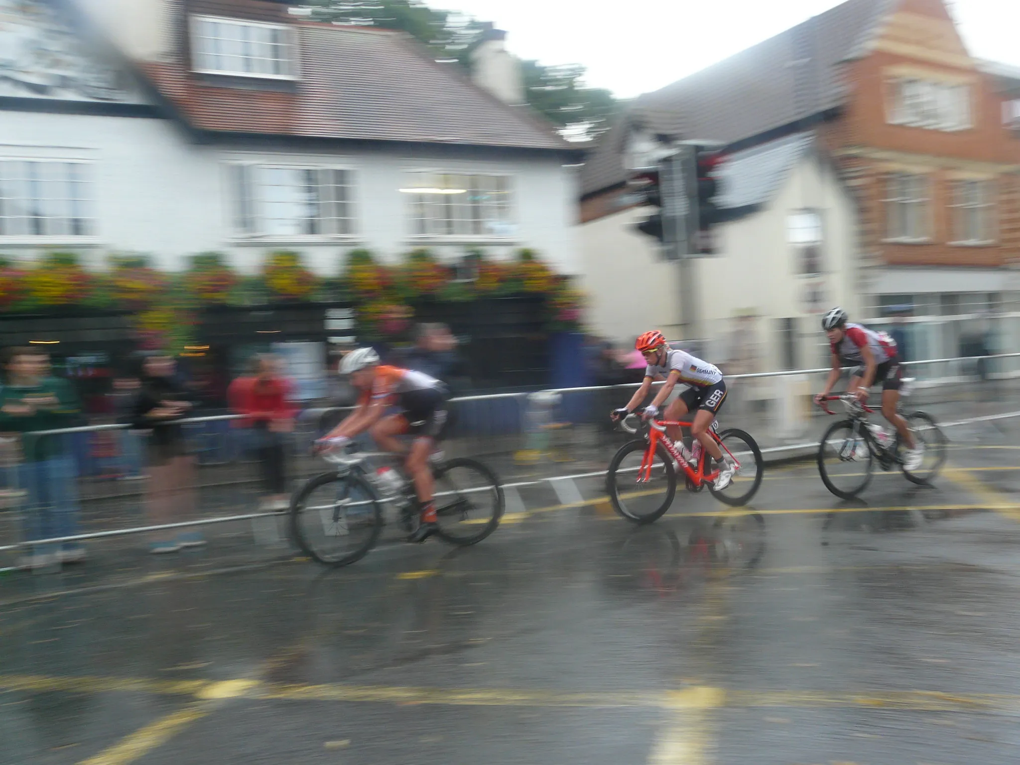 Cyclists racing through a wet town in the 2012 Olympic women’s road race