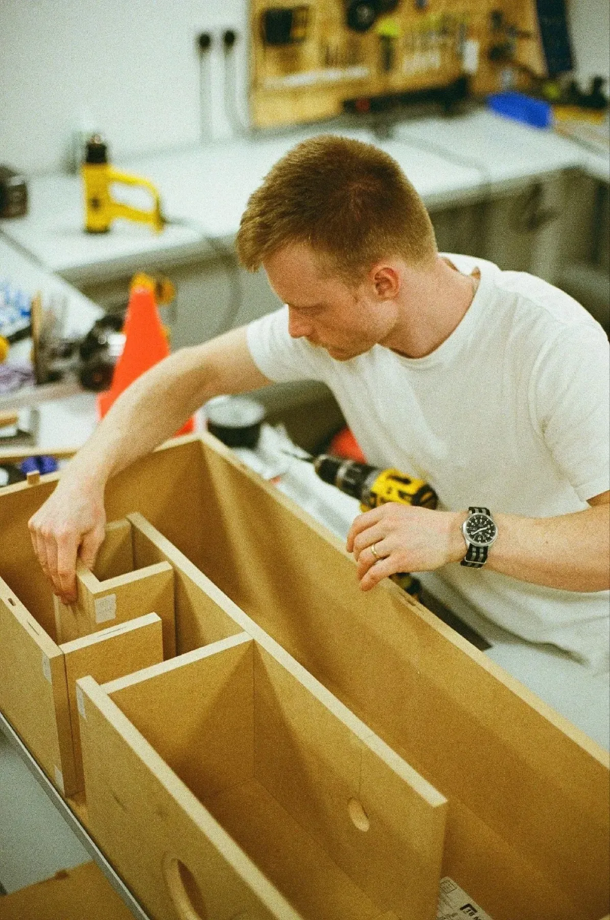 Film photograph: Toby building a plywood speaker in a workshop